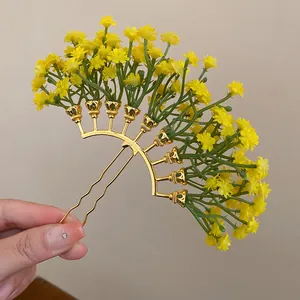 Detail showing yellow Gypsophila flower hair stick with golden U-pin base