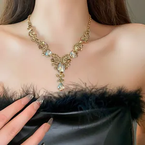Elegant detail of a vintage teardrop rhinestone clavicle necklace on a fashion model