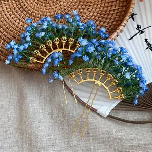 Close-up detail of blue baby's breath flower hair fork with a golden fan-shaped base