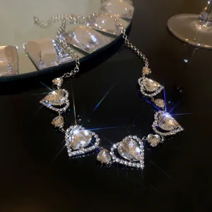 Close-up of luxury heart-shaped rhinestone necklace on reflective black background