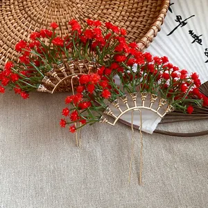 Close-up of red gypsophila flower hairpins with gold-tone U-shaped metal base