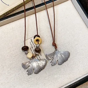 Vintage ginkgo leaf pendant necklace with wooden beads in a light luxury style