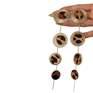 Vintage leopard print dangling earrings with long circular resin drops and gold-tone finish.
