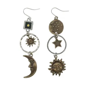 Vintage asymmetric dangling earrings featuring celestial sun, moon, and star motifs
