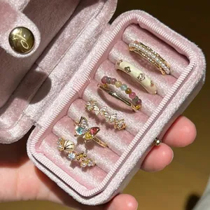 Elegant zircon butterfly pearl rings set displayed in a pink velvet jewelry box