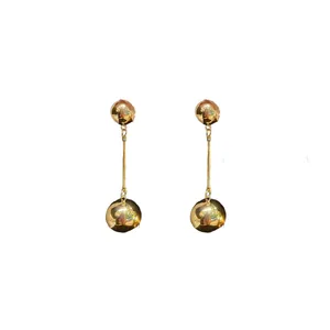 Minimalist gold spherical drop earrings featuring a sleek long bar and tassel design