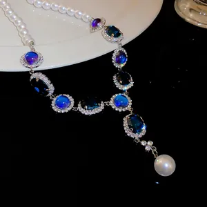 Detailed view of French vintage pearl necklace with blue rhinestones and crystal accents