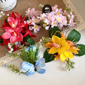 Detailed view of colorful fabric flower hair clips with butterfly and leaf accents