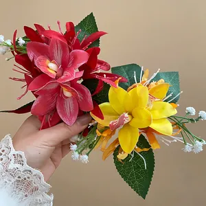 Detailed shot of handmade fabric orchid hair clips in vibrant red and yellow hues