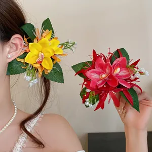 Detail shot of vibrant yellow and red fabric floral hair clips worn by a model