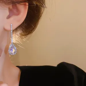 Elegant close-up view of French luxury water drop rhinestone earrings worn by a model
