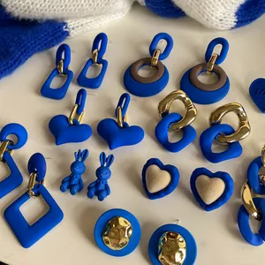 Collection of Klein Blue matte earrings featuring heart, rabbit, and geometric designs.