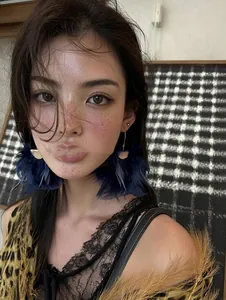 Close-up detail of fashion blue feather tassel earrings worn by a female model