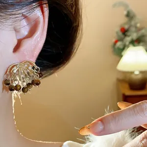 Vintage firework earrings with tiger eye stone and crystals, gold-tone tassel design.