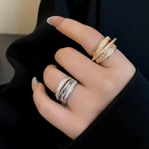Macro detail of elegant silver and gold zircon multi-layer geometric open rings on model's hand