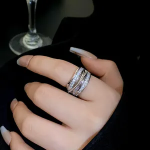 Close-up of multi-layer zircon geometric open ring on finger