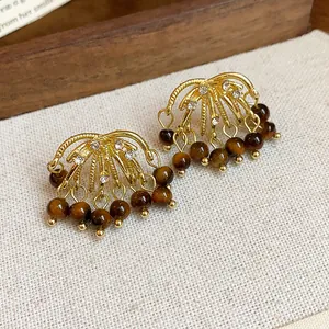 Detail of vintage firework earrings with sparkling rhinestones and tiger eye stone beads