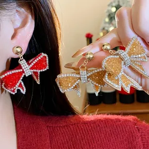 Exquisite sparkling resin bowknot earrings with rhinestones in red and gold finish
