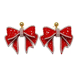 Elegant red resin bow earrings with sparkling crystal rhinestones and silver pins.