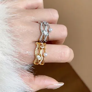 Elegant 18k gold plated wavy ring featuring sparkling zircons and delicate pearls
