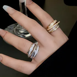 Detailed view of luxury multi-layer geometric open rings with sparkling cubic zirconia stones.
