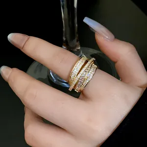 Close-up detail of luxury gold multi-layer ring paved with white sparkling zircons for women