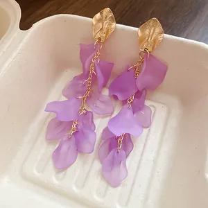 Detailed view of vintage style purple frosted petal tassel drop earrings with gold leaf accents