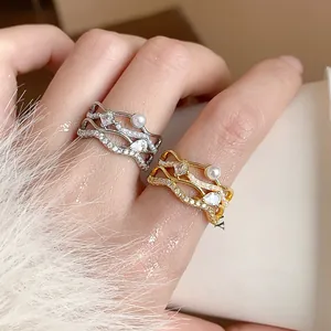 Close-up of 18k gold plated wavy rings with pearls and sparkling zircons