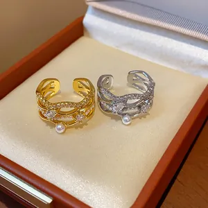 Detailed view of elegant 18k gold plated rings with pearls and zircons in box