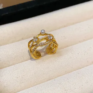Detail view of 18k gold plated ring featuring sparkling zircons and an elegant pearl.