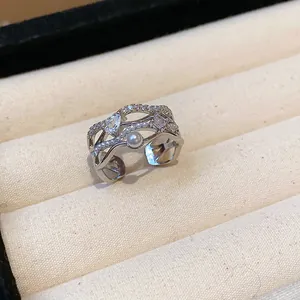 Detailed macro view of an elegant 18k gold plated wavy ring with zircon and pearls