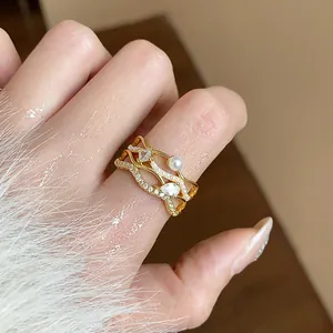 Detailed macro view of an 18k gold plated ring with sparkling zircons and pearls