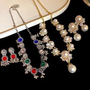 Detailed view of vintage palace style necklace sets with pearls and colorful rhinestones.