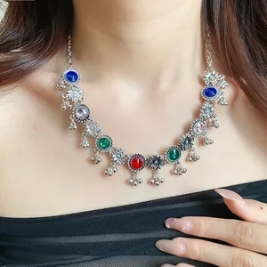 Close-up of vintage court-style necklace with multi-colored rhinestones and floral pendants