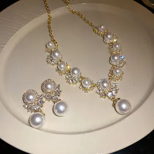 Close-up detail of a vintage palace style pearl and diamond necklace with earring set