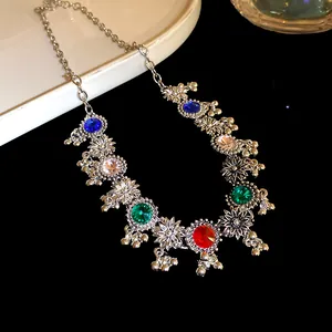 Detail view of vintage court style necklace with colorful rhinestones and floral pendants