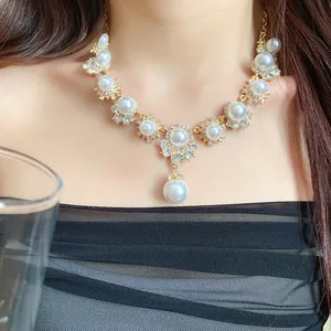 Vintage palace style pearl and rhinestone choker necklace on a model.