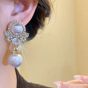 Close-up of elegant vintage palace style earring with large pearls and sparkling rhinestones