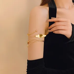 Elegant leaf-shaped gold arm cuff bracelet shown on model for a detailed style view.