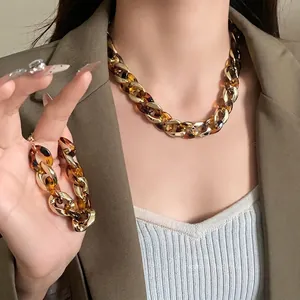 Chunky leopard print resin and gold metal chain necklace and bracelet set for women.