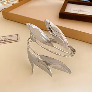 Close-up of a silver leaf open cuff bracelet with detailed leaf pattern engraving.