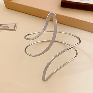 Minimalist silver-toned spiral open bangle with a sculptural leaf-inspired design for women