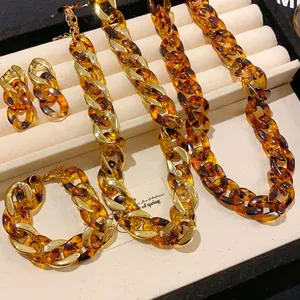 Detailed view of tortoiseshell resin and gold link jewelry set in a display box