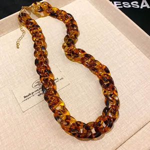 Detail view showing the tortoiseshell resin texture of a chunky chain statement necklace