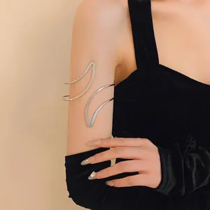 Detailed close-up of a minimalist silver geometric open arm cuff worn on the upper arm