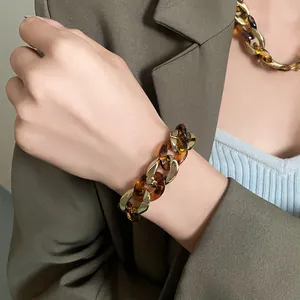 Vintage tortoiseshell and gold chunky chain bracelet and necklace styled on a model