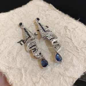 Elegant silver needle drop earrings with blue waterdrop stones and sparkling crystals