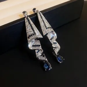 Elegant silver-tone drop earrings with sparkling rhinestones and blue teardrop crystals
