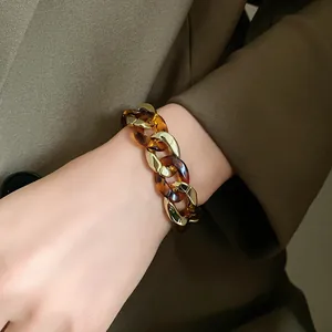 Elegant tortoiseshell resin and gold metal chunky link chain bracelet detail