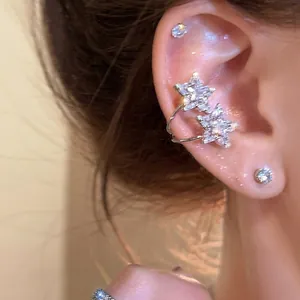 Sparkling star ear cuff with zircon stones on model ear for elegant Korean style jewelry